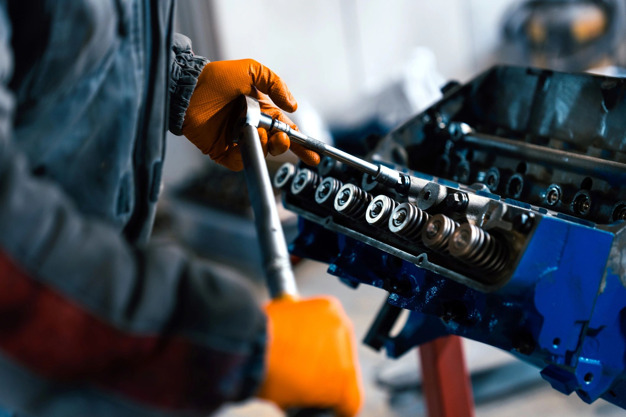 Mechanic measuring an engine component in a repair shop